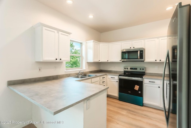 94 Castle Ridge Dr, New Castle, CO 81647 - kitchen featuring stainless steel appliances, a peninsula, white cabinetry, light wood-type flooring, and recessed lighting