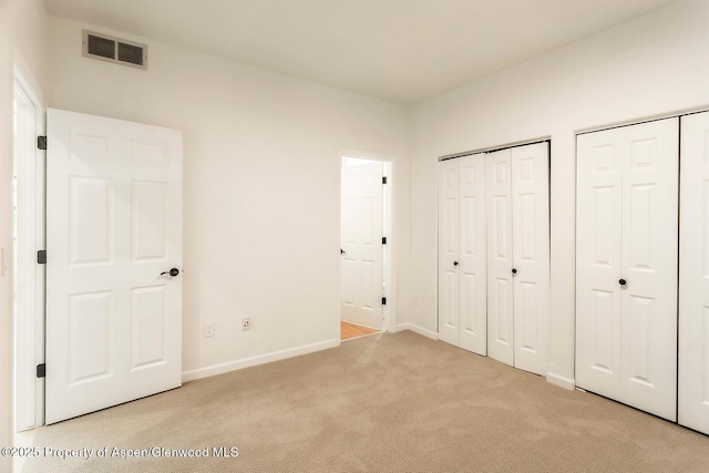 94 Castle Ridge Dr, New Castle, CO 81647 - unfurnished bedroom with light carpet and multiple closets