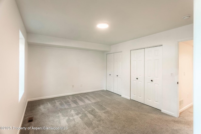94 Castle Ridge Dr, New Castle, CO 81647 - unfurnished bedroom featuring two closets and carpet floors