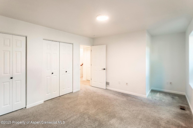 94 Castle Ridge Dr, New Castle, CO 81647 - unfurnished bedroom with two closets and carpet floors