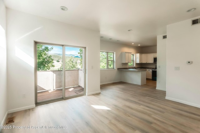 94 Castle Ridge Dr, New Castle, CO 81647 - unfurnished living room with light wood-style flooring and recessed lighting