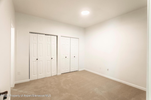 94 Castle Ridge Dr, New Castle, CO 81647 - unfurnished bedroom with multiple closets and light colored carpet