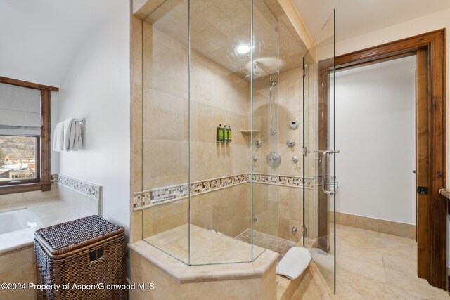 bathroom with an enclosed shower and lofted ceiling