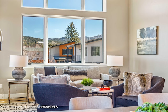 living area with wood finished floors and baseboards