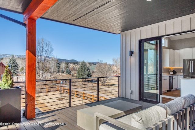 wooden deck featuring a mountain view