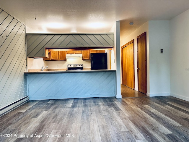 kitchen featuring electric stove, black refrigerator, wooden walls, dark hardwood / wood-style flooring, and kitchen peninsula