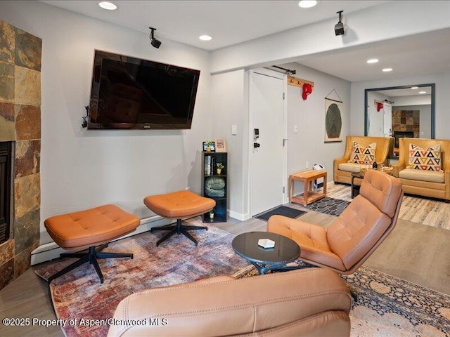 326 Midland Ave Unit 302, Aspen, CO 81611 - living room featuring wood finished floors, recessed lighting, and a tiled fireplace