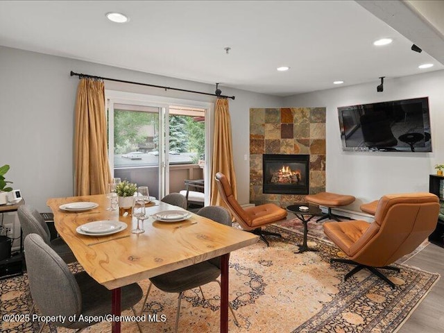326 Midland Ave Unit 302, Aspen, CO 81611 - dining room with recessed lighting, a tile fireplace, wood finished floors, and a baseboard heating unit