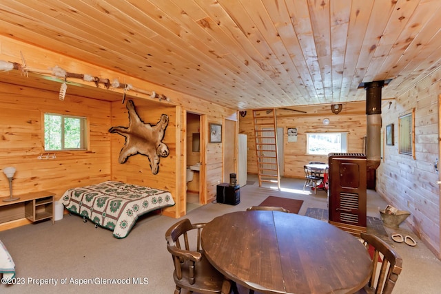 interior space featuring wooden ceiling and wood walls