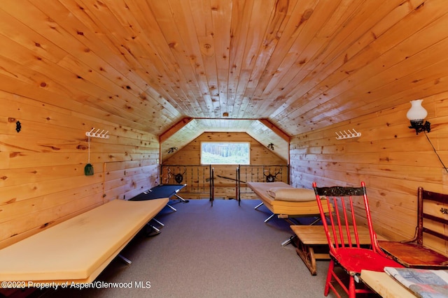 bedroom featuring carpet, lofted ceiling, wooden ceiling, and wood walls