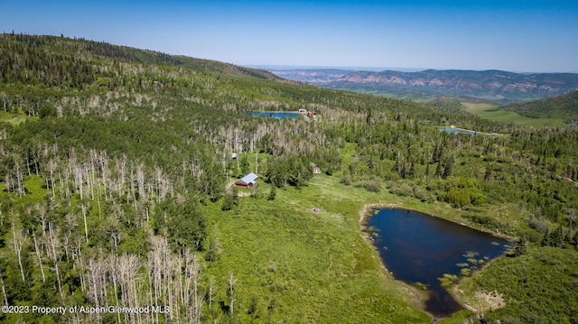 aerial view featuring a water and mountain view