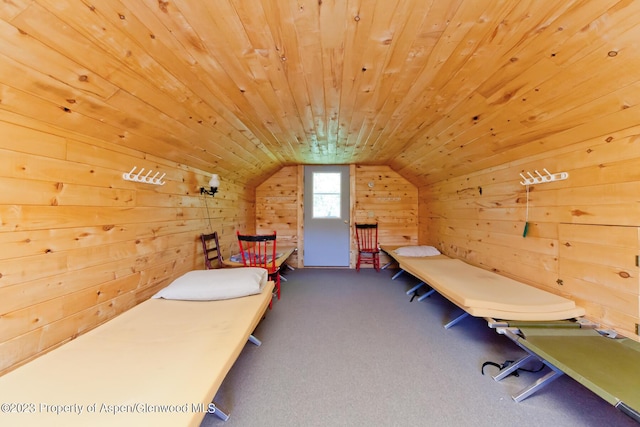 bedroom with wood walls, carpet, wood ceiling, and vaulted ceiling