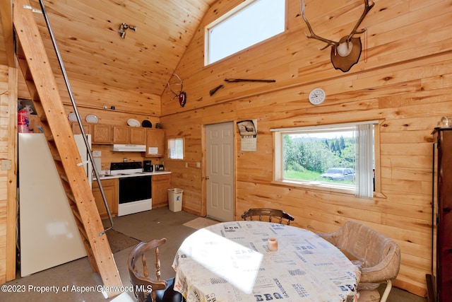 dining area with high vaulted ceiling, wood ceiling, and wooden walls