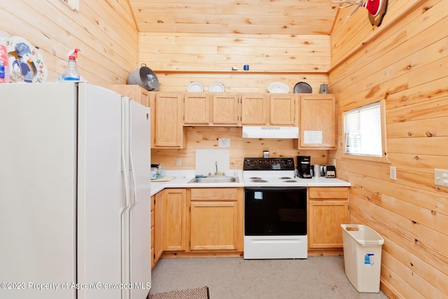 kitchen with light brown cabinetry, white appliances, and wooden walls