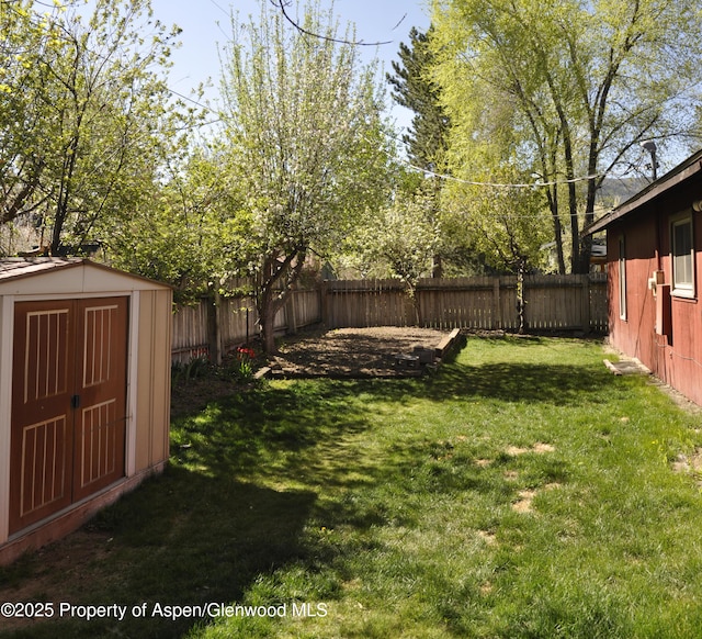view of yard with a storage shed and an outbuilding