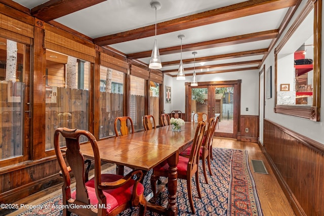 126 W Francis St, Aspen, CO 81611 - dining room with wood finished floors, wainscoting, beamed ceiling, wooden walls, and french doors