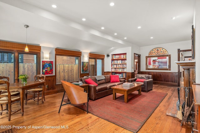 126 W Francis St, Aspen, CO 81611 - living area with wainscoting, hardwood / wood-style floors, recessed lighting, lofted ceiling, and wood walls