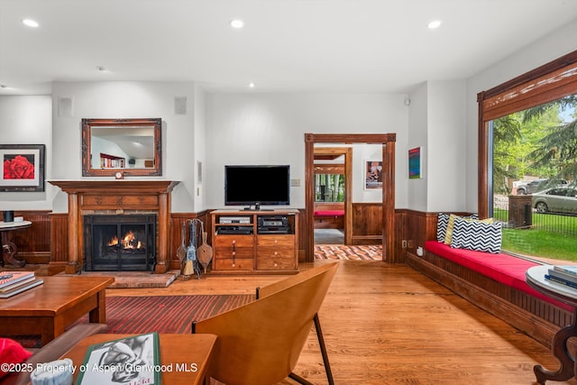 126 W Francis St, Aspen, CO 81611 - living area featuring a wainscoted wall, wood finished floors, recessed lighting, a lit fireplace, and wooden walls