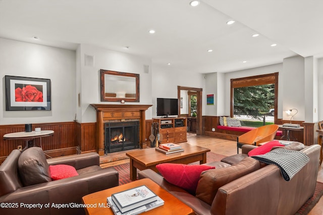 126 W Francis St, Aspen, CO 81611 - living area with wood finished floors, wainscoting, recessed lighting, a warm lit fireplace, and wooden walls