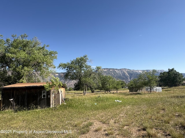 245 County Road 338, Parachute, CO 81635 - view of yard featuring a mountain view, a rural view, and an outbuilding