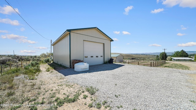 25 W 20th St, Craig, CO 81625 - detached garage with driveway and a rural view