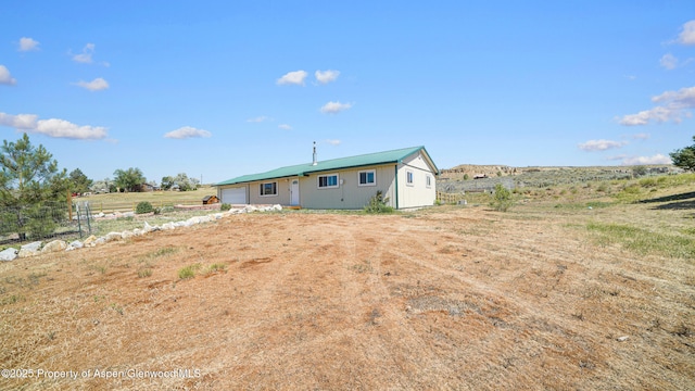 25 W 20th St, Craig, CO 81625 - back of house featuring a garage and a view of countryside