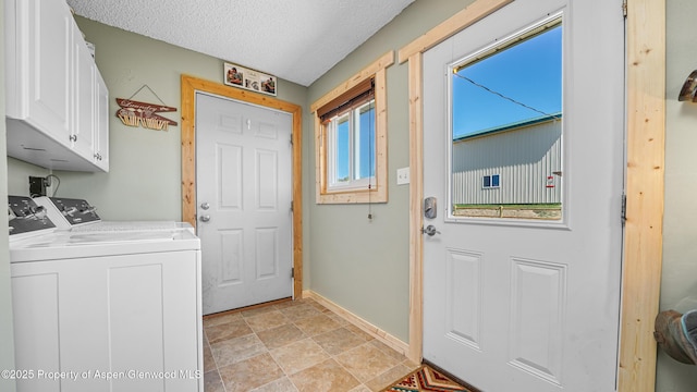 25 W 20th St, Craig, CO 81625 - washroom with cabinet space, washing machine and clothes dryer, a textured ceiling, and light stone finish floors
