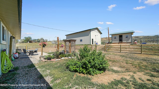 25 W 20th St, Craig, CO 81625 - view of yard featuring a patio area, an outbuilding, and a view of rural / pastoral area