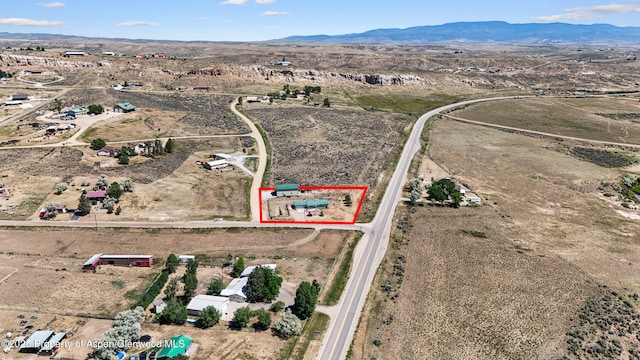 25 W 20th St, Craig, CO 81625 - aerial view of property and surrounding area with property boundaries highlighted, a mountainous background, and rural landscape