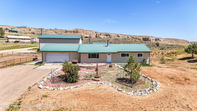 25 W 20th St, Craig, CO 81625 - single story home with driveway, a garage, a metal roof, and a mountain view