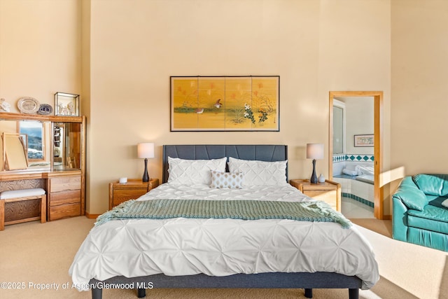 carpeted bedroom featuring a towering ceiling