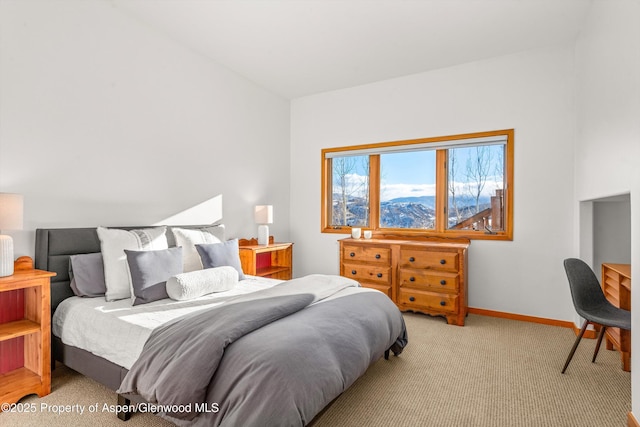 bedroom featuring a mountain view and light carpet