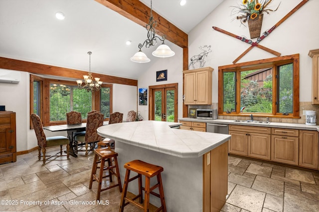 117 Deer Ln, Marble, CO 81623 - kitchen with stainless steel appliances, a wall mounted air conditioner, stone tile flooring, backsplash, and beam ceiling