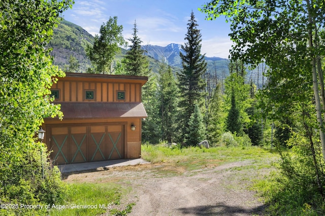 117 Deer Ln, Marble, CO 81623 - garage with dirt driveway and a mountain view