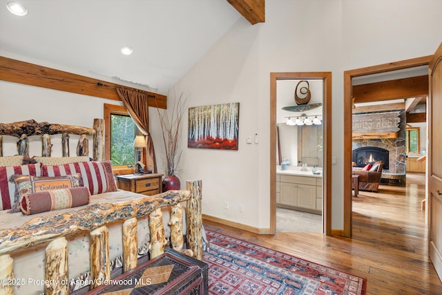 117 Deer Ln, Marble, CO 81623 - bedroom featuring hardwood / wood-style flooring, beamed ceiling, high vaulted ceiling, a stone fireplace, and recessed lighting