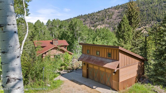 117 Deer Ln, Marble, CO 81623 - exterior space with a wooded view, a detached garage, and an outbuilding