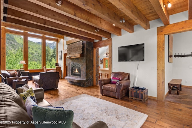 117 Deer Ln, Marble, CO 81623 - living room featuring a wood ceiling with exposed beams, hardwood / wood-style floors, and a stone fireplace