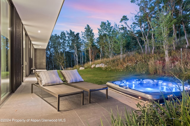 542 Carroll Dr, Aspen, CO 81611 - patio terrace at dusk featuring a hot tub and a yard
