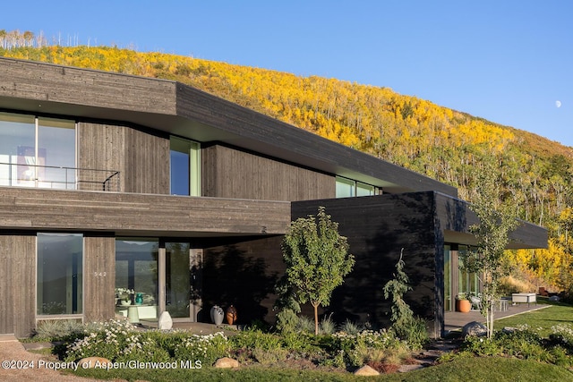 542 Carroll Dr, Aspen, CO 81611 - rear view of house featuring a wooded view