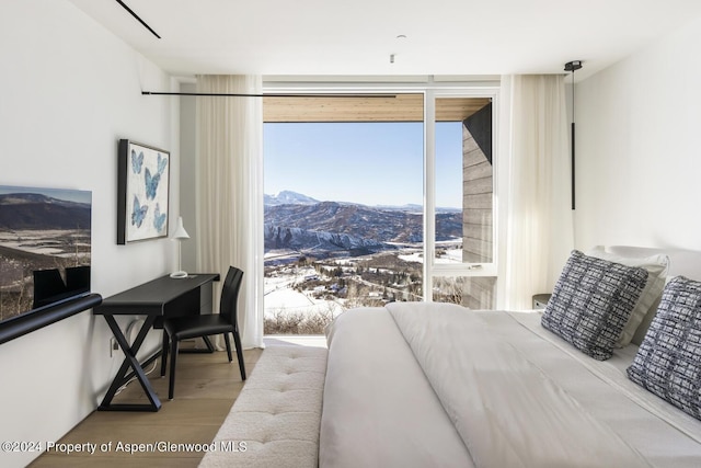 542 Carroll Dr, Aspen, CO 81611 - bedroom with wood finished floors, a wall of windows, and a mountain view
