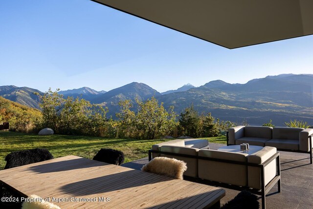 542 Carroll Dr, Aspen, CO 81611 - wooden deck featuring a mountain view, an outdoor hangout area, and a yard