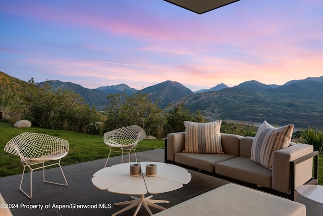 542 Carroll Dr, Aspen, CO 81611 - patio terrace at dusk with an outdoor hangout area, a mountain view, and a yard