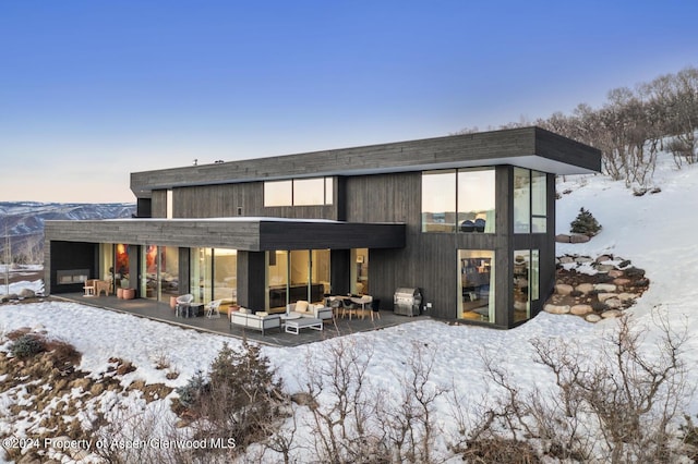 542 Carroll Dr, Aspen, CO 81611 - snow covered rear of property featuring outdoor lounge area and a patio area