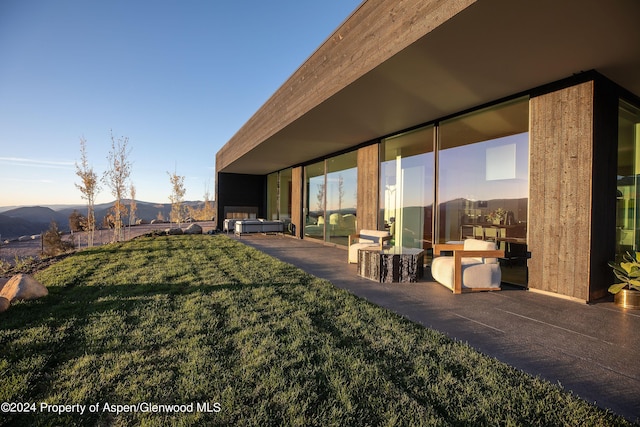 542 Carroll Dr, Aspen, CO 81611 - view of green lawn with a patio area and a mountain view