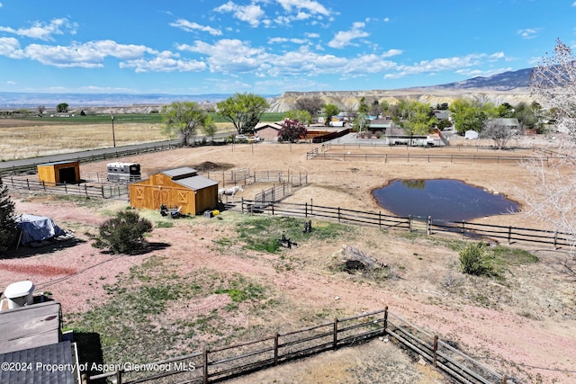 aerial view featuring a rural view and a water and mountain view