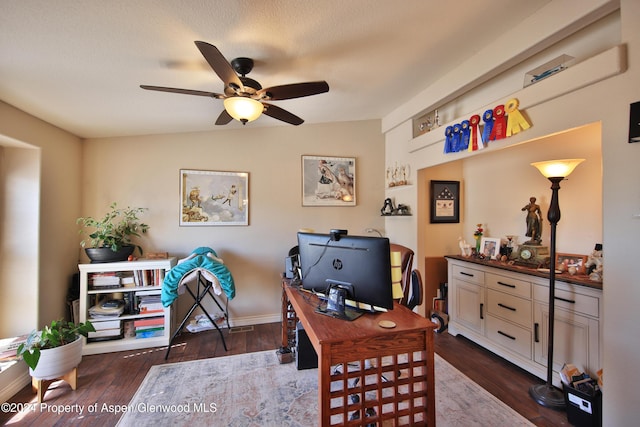 home office with dark hardwood / wood-style floors and ceiling fan