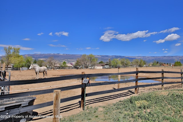 view of yard featuring a rural view and a water and mountain view