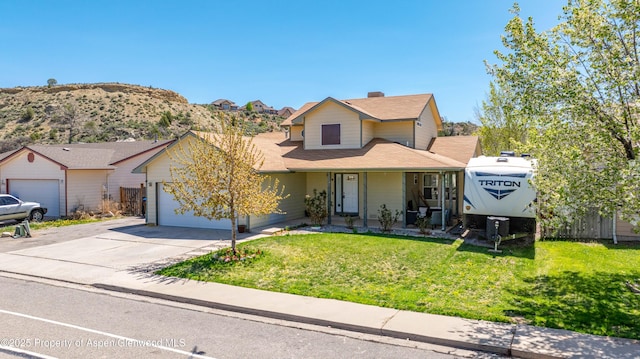 2086 Acacia Ave, Rifle, CO 81650 - traditional home featuring an attached garage, driveway, a front yard, and covered porch