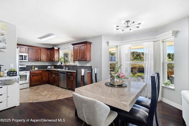 2086 Acacia Ave, Rifle, CO 81650 - kitchen with appliances with stainless steel finishes and a chandelier