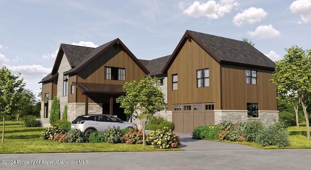 view of front of property with a front yard and a garage